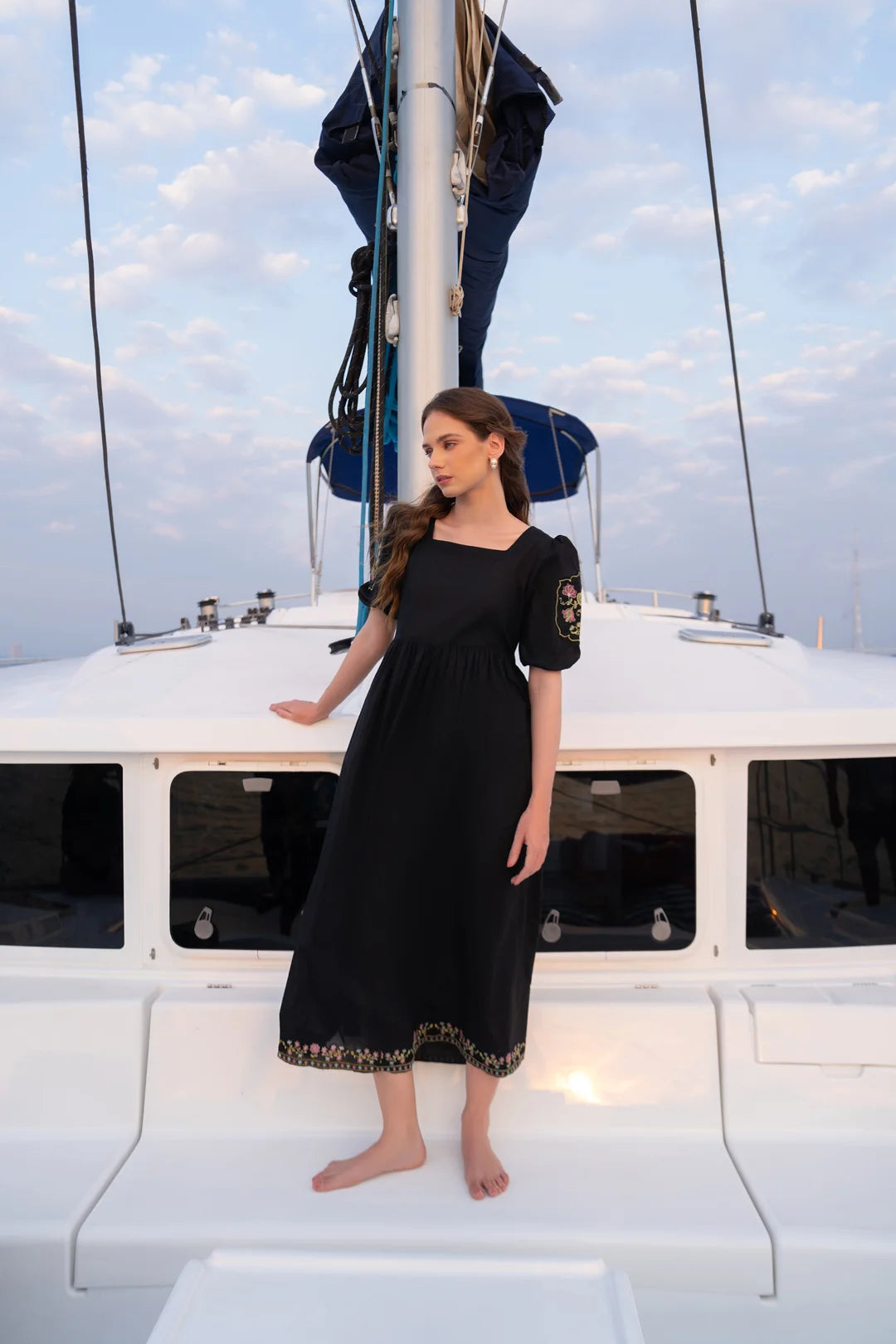 Women wearing black cambric frock midi length - casual evening wear