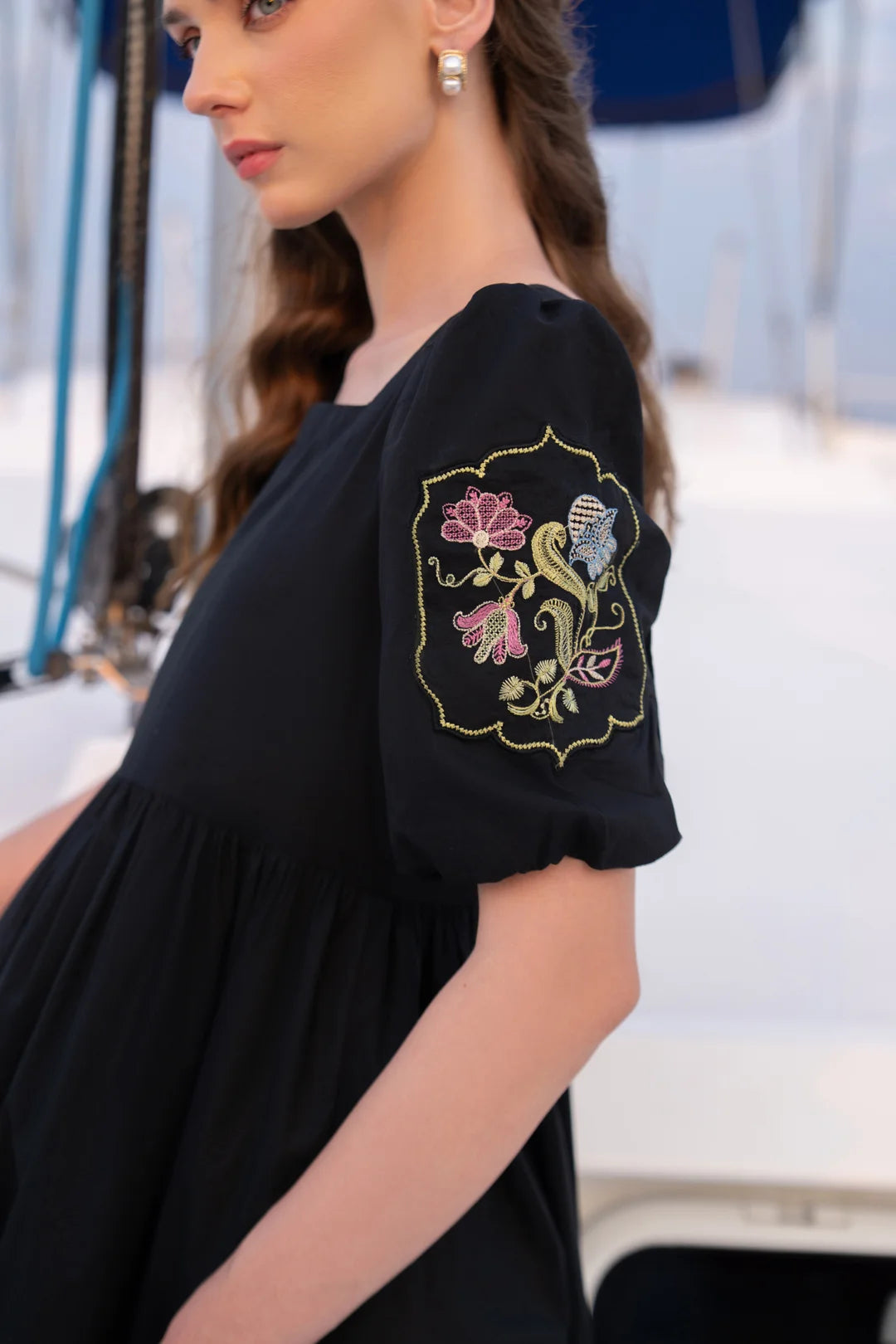 Gold embroidery detail on sleeve of black cambric frock - Beyond East women's pret