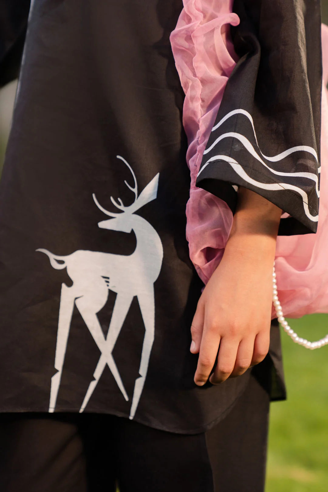 Designer black suit girl detail Pakistan - lawn 2 piece tween outfit white floral embroidery Eid formal wear closeup Beyond East