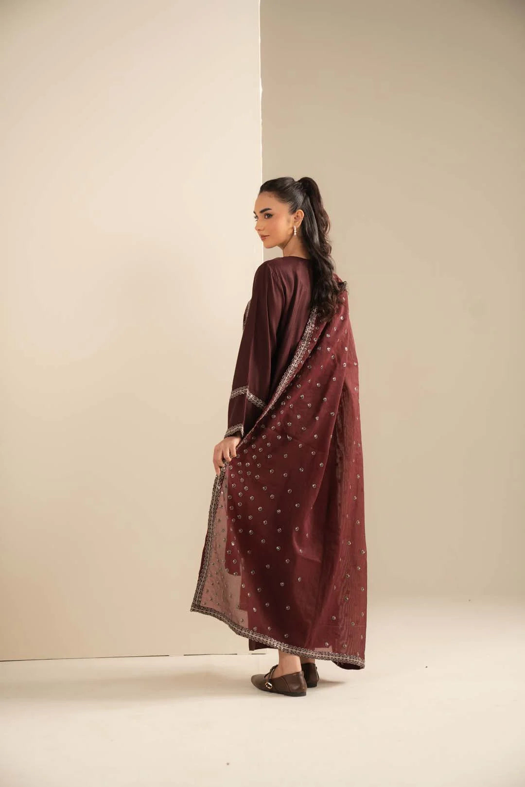 Detail shot of maroon dupatta/shawl drape showing print/embellished accents and fall.