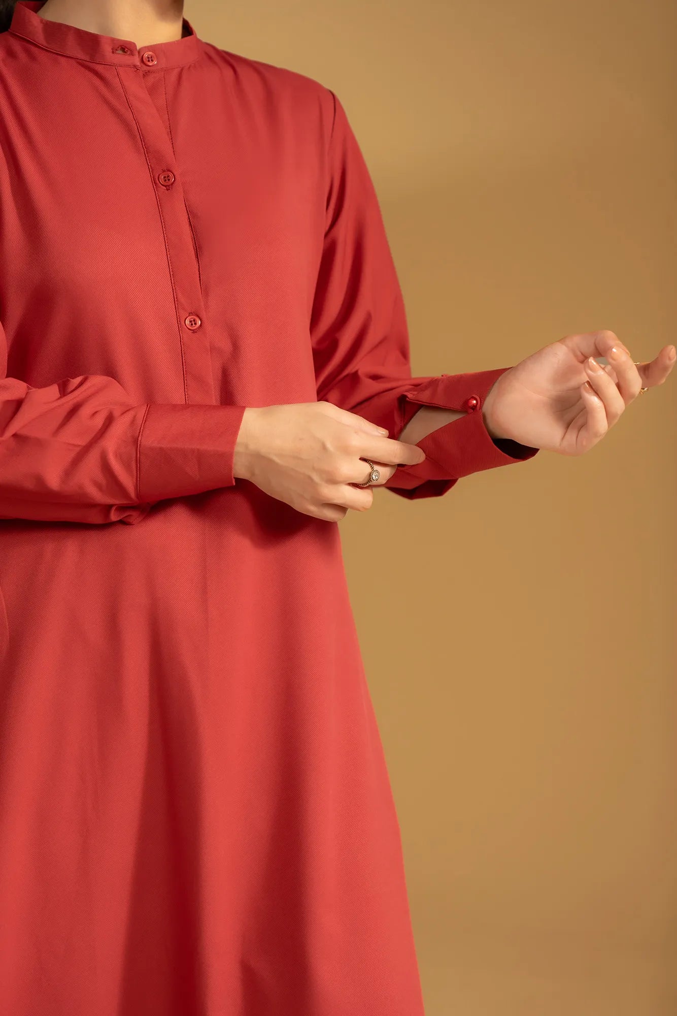 Detailed view of the button placket and band collar on a classic maroon kurta for women.