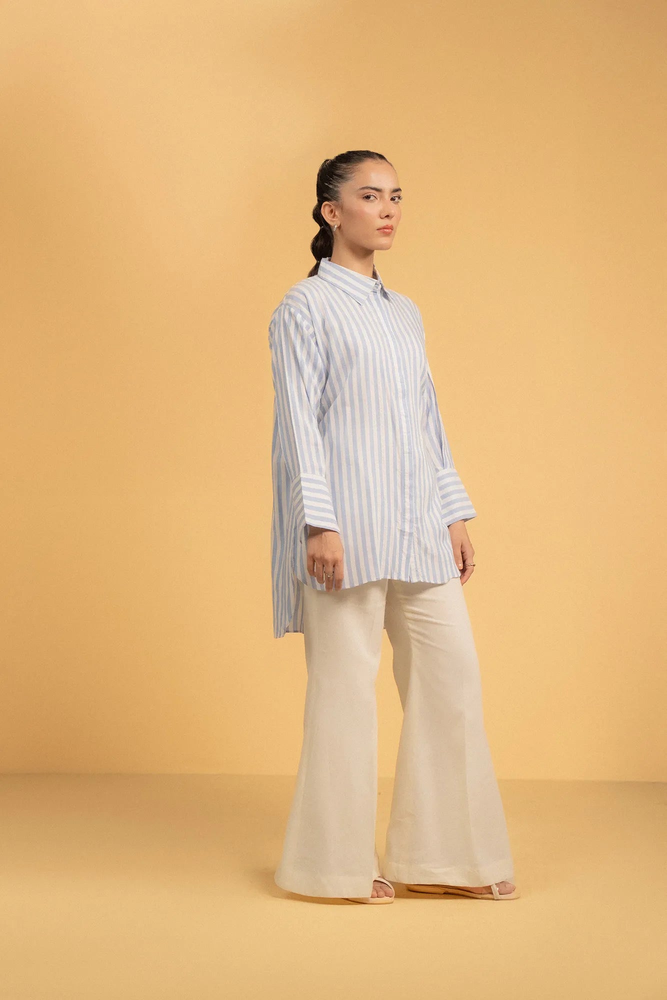 Detailed view of the wide, folded cuff on a stylish blue and white striped shirt