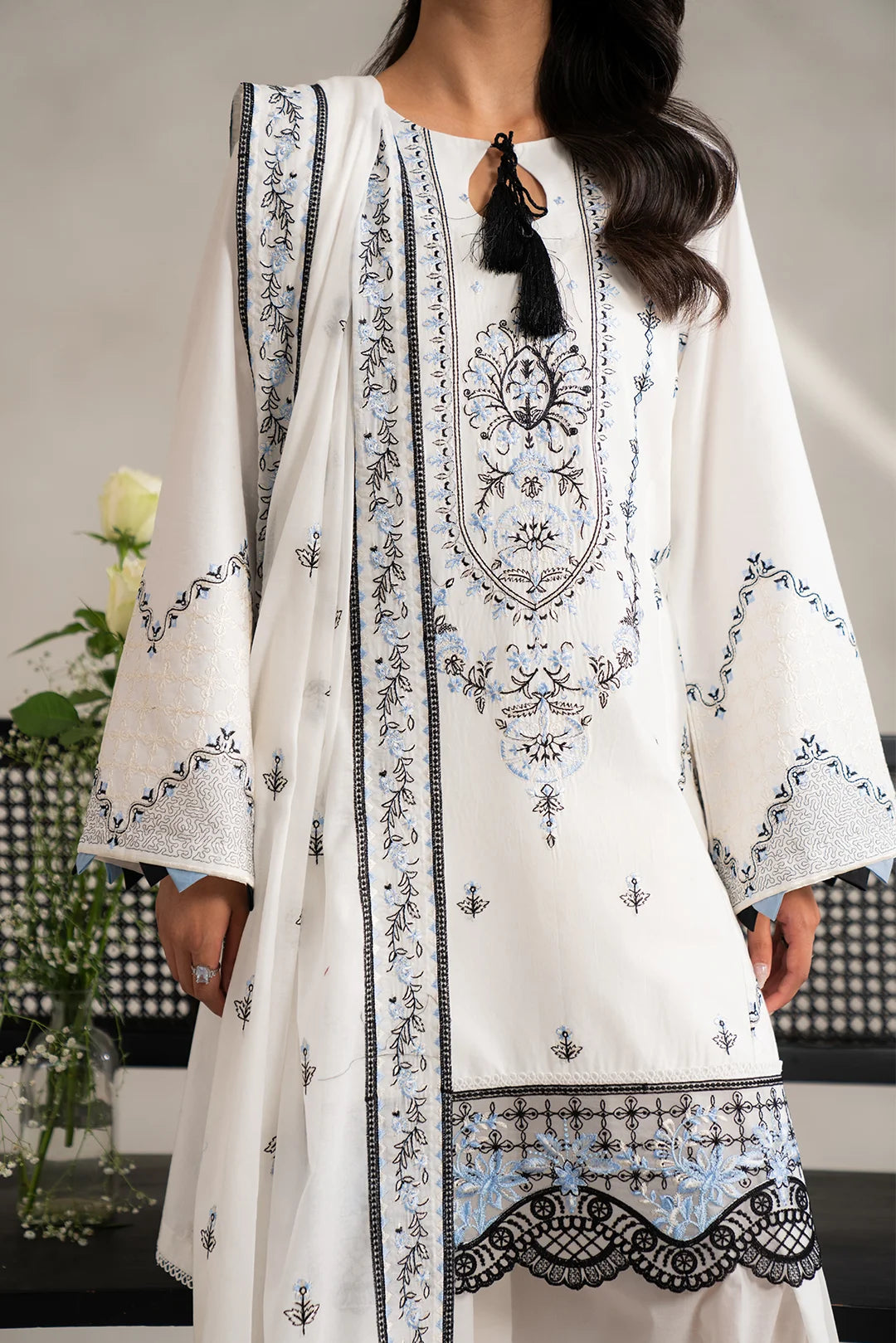 Elegant 3 piece unstitched lawn suit in black and white with detailed embroidery and lace.