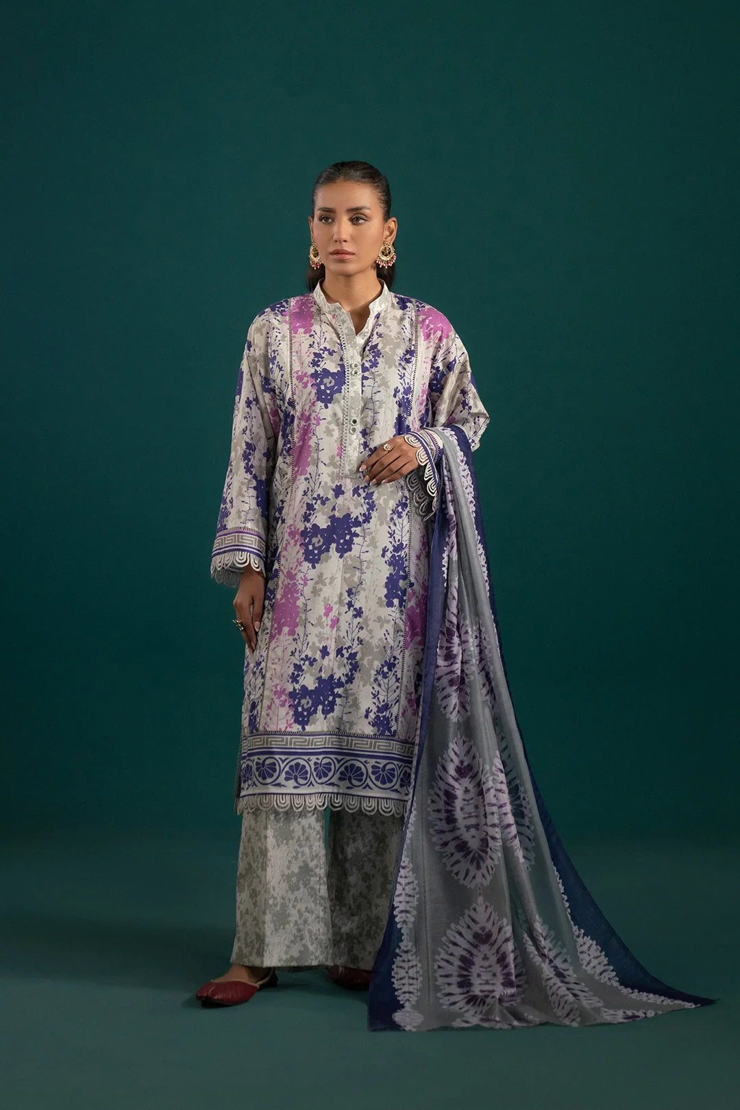Elegant lawn suit with floral bunches on a grey base, paired with an ikkat-patterned monark dupatta – a trendy lawn suit design for summer.