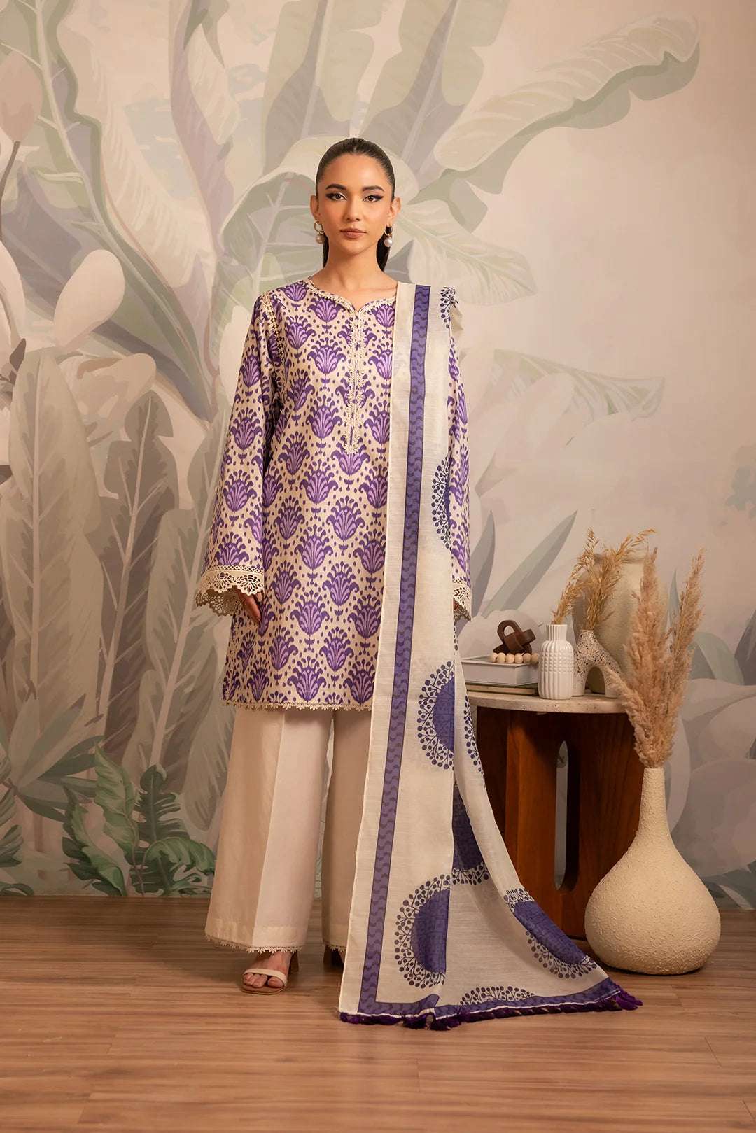 Elegant printed lawn dress design featuring an ikkat-patterned shirt with a bold Monark dupatta in striking purple hues on an off-white base.