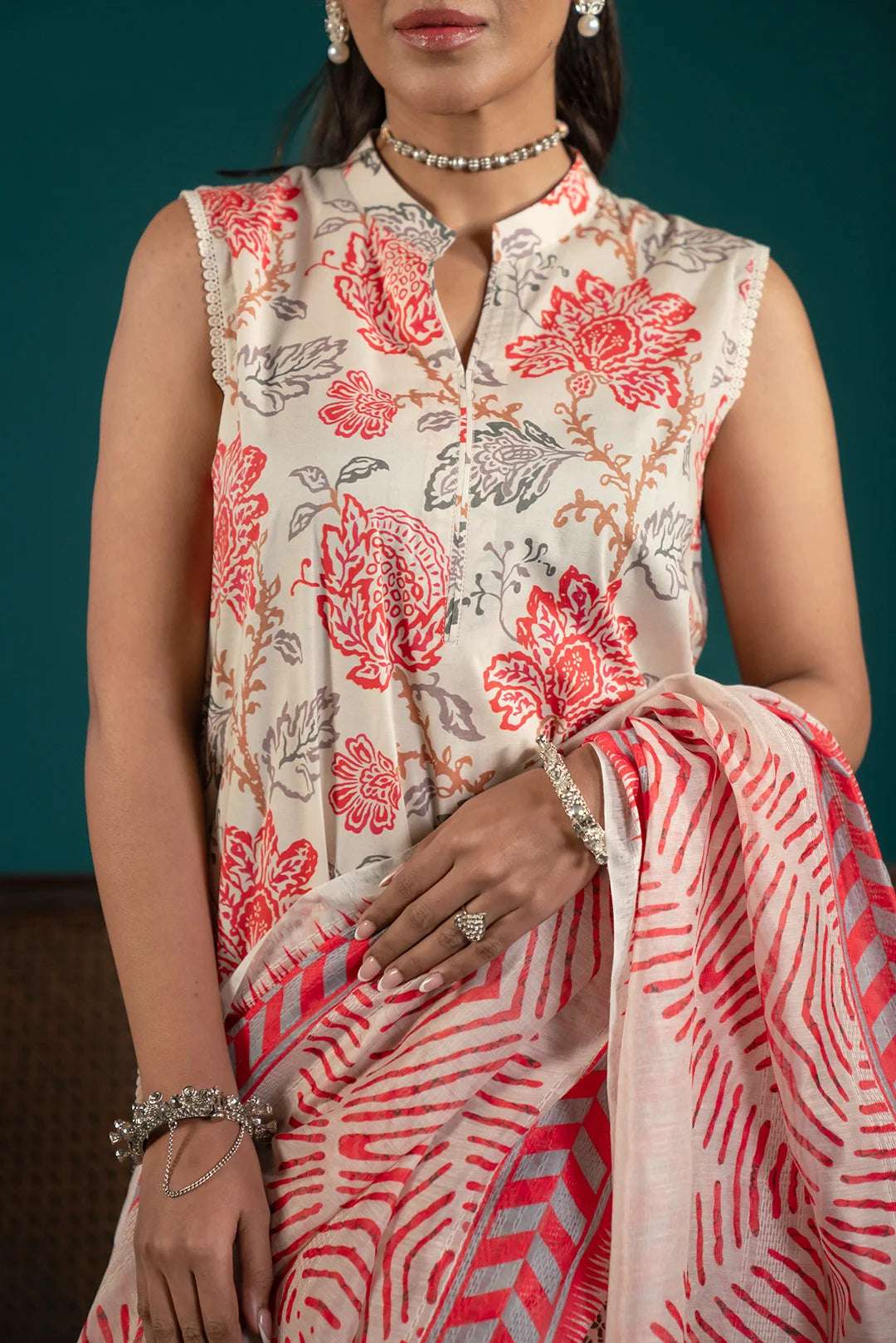 Elegant summer lawn suit with intricate digital prints, a bold red monark dupatta, and matching cambric trousers for a complete look.