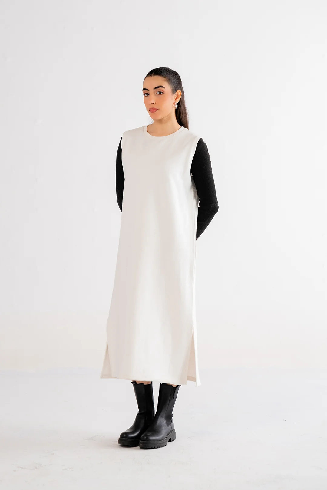 Elegant white maxi dress with layered black sleeves, creating a stylish monochrome ensemble.