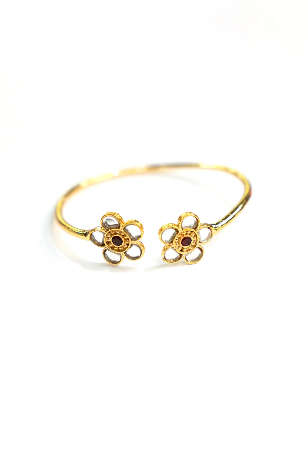 Gold plated floral open cuff bangle with red stone centre by Beyond East