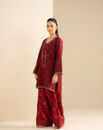 Front full-length view of red khaddar embroidered shirt and printed slub shalwar