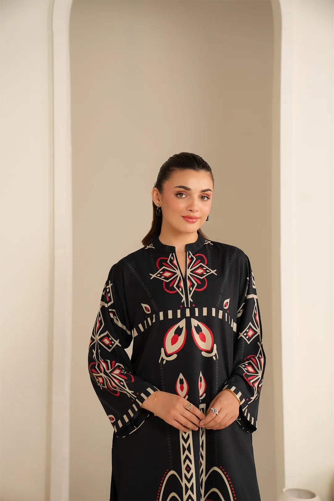 Front pose in black printed linen shirt, modern modest silhouette