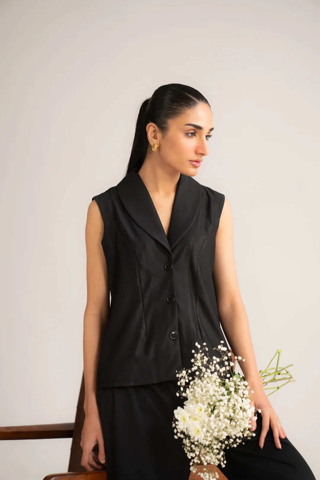 Front pose of black cropped vest and wide-leg trouser set for women
