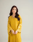 Front pose of mustard raw silk kaftan with embroidered neckline and loose sleeves