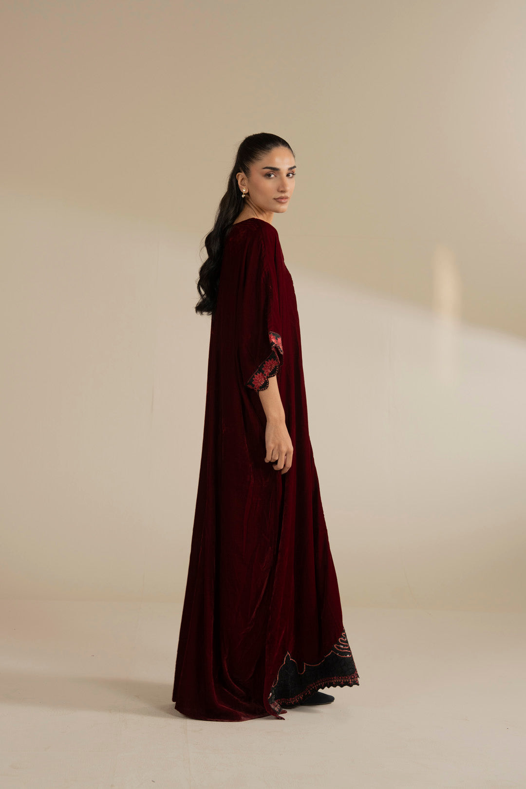 Front silhouette of the velvet kaftan showing its relaxed fall and straight hem finish.
