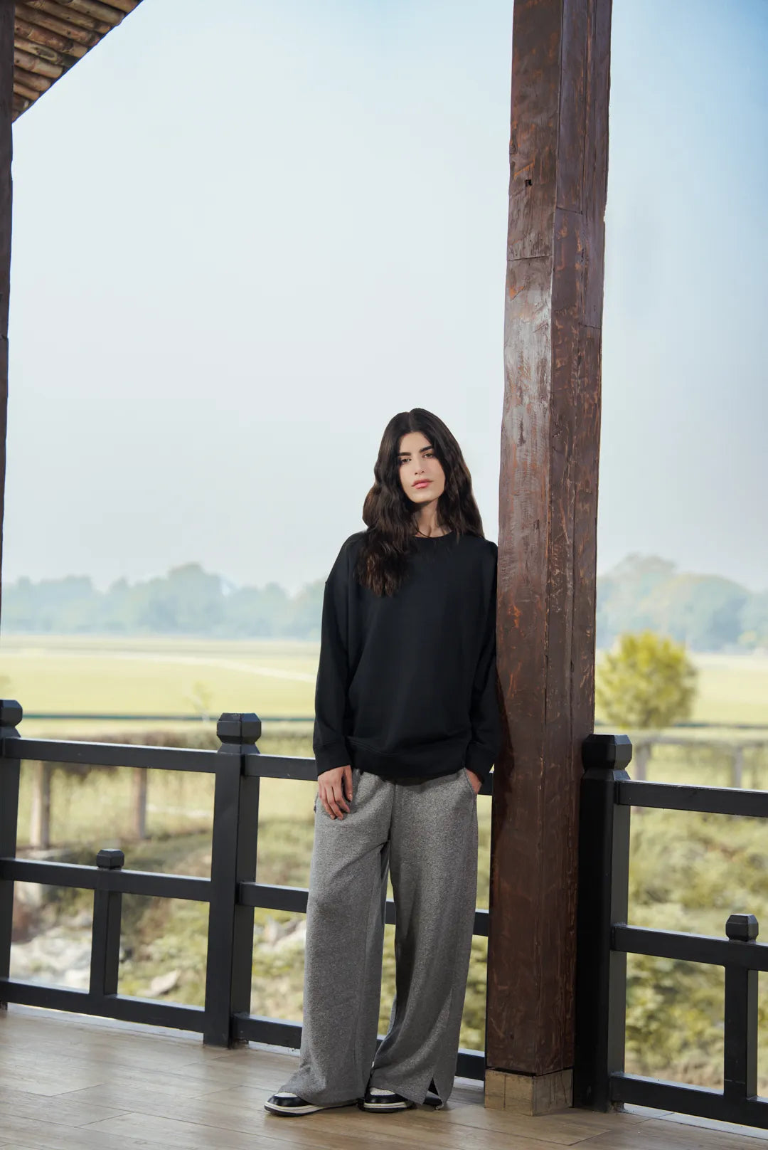 Front view of black sweatshirt outfit showing straight silhouette