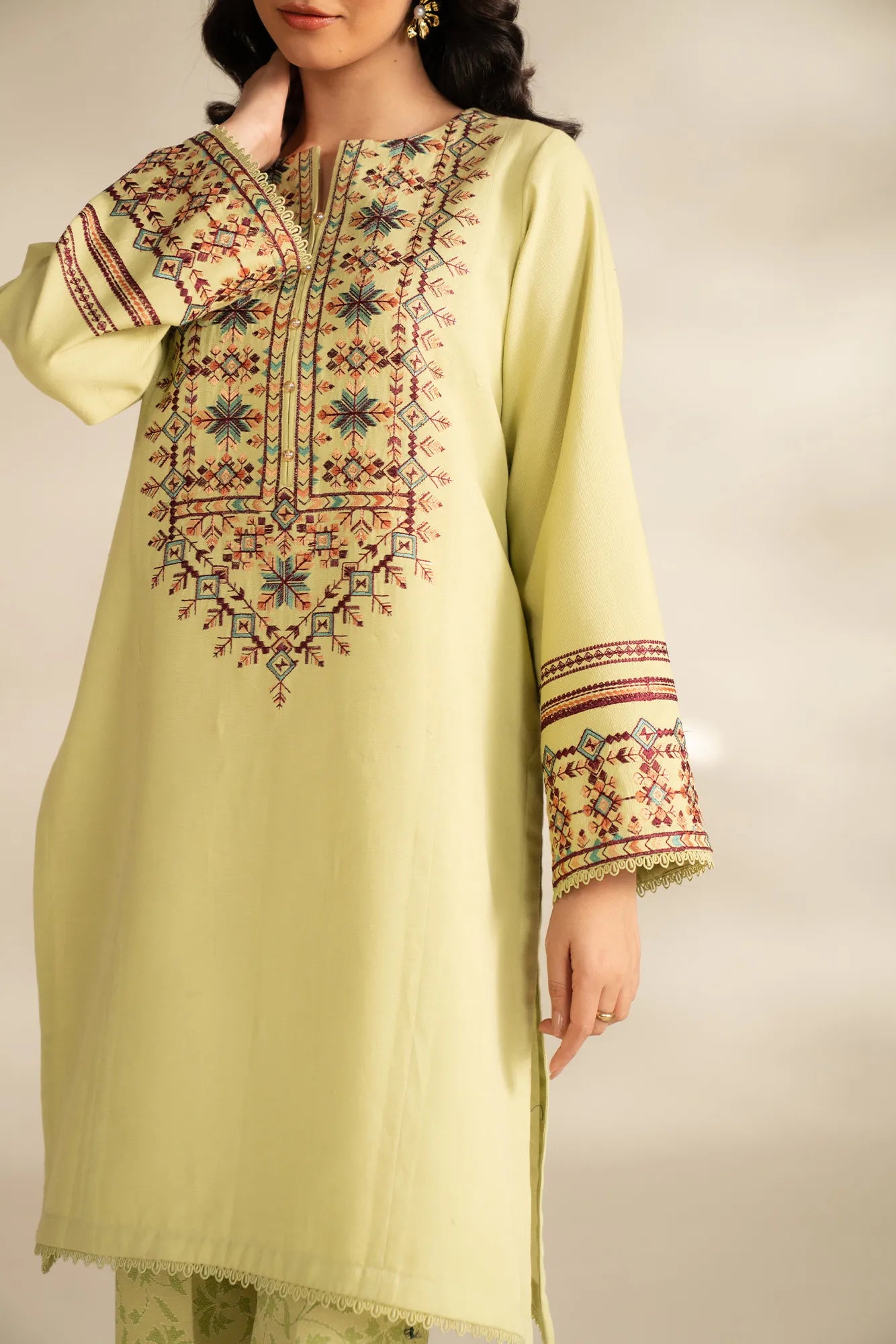 Front view of embroidered khaddar shirt panels on pastel winter unstitched suit