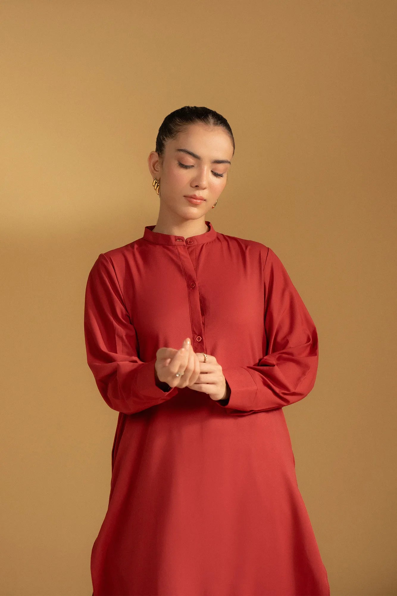 Full-length shot of a model wearing a maroon kurta, highlighting the straight cut and relaxed fit.