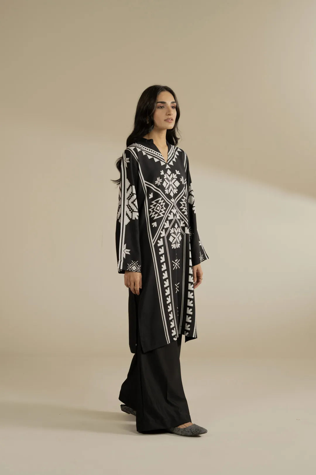 Full-length shot of black linen kurta-style shirt, clean straight silhouette with bold white print
