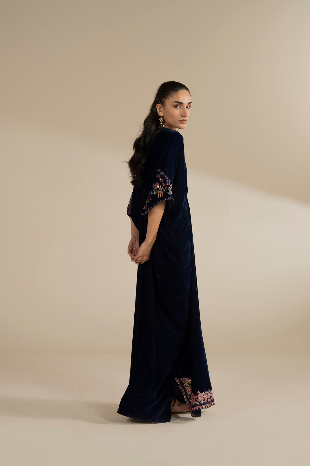 Full-length side angle showing kaftan length, fall, and silhouette on the body.