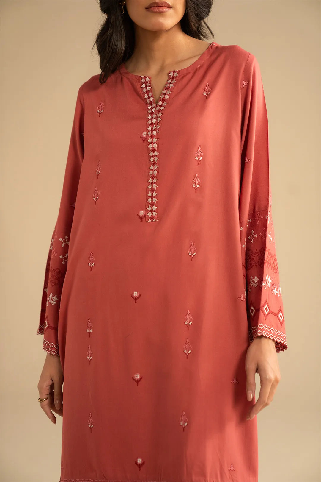 Full-length styling of the orange 3-piece suit with straight trousers and flowing shawl fall.