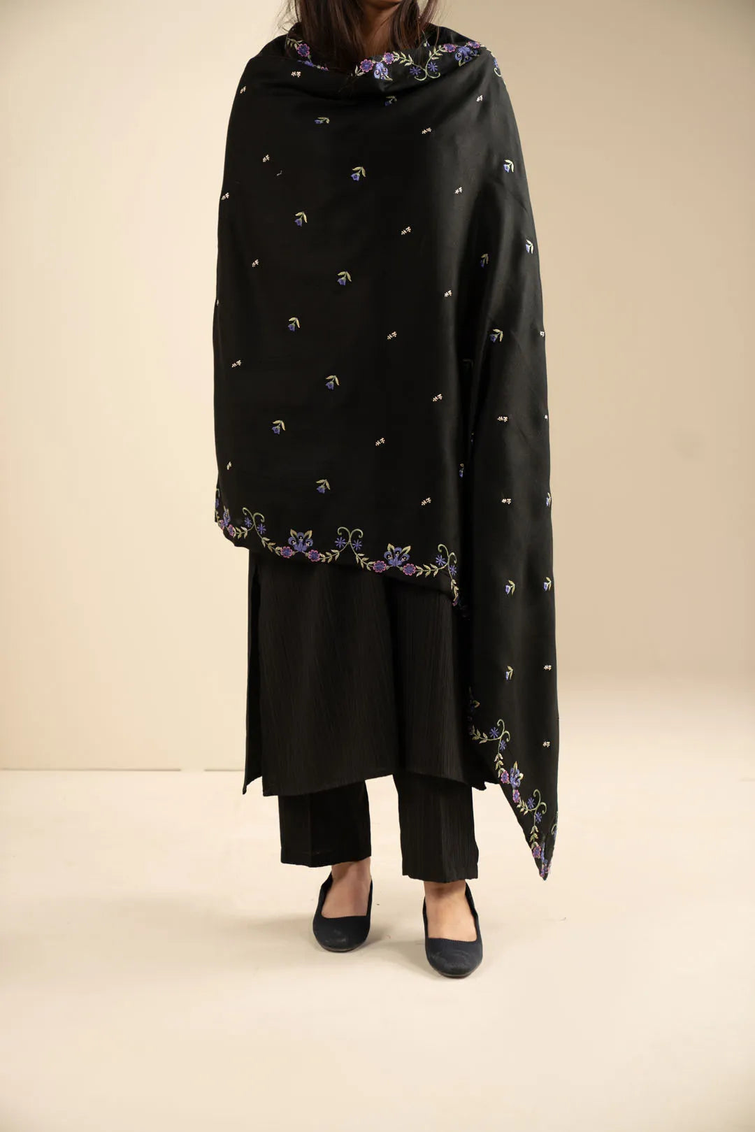 Full-length styling shot showing the shawl worn as a winter wrap with subtle embroidered accents.
