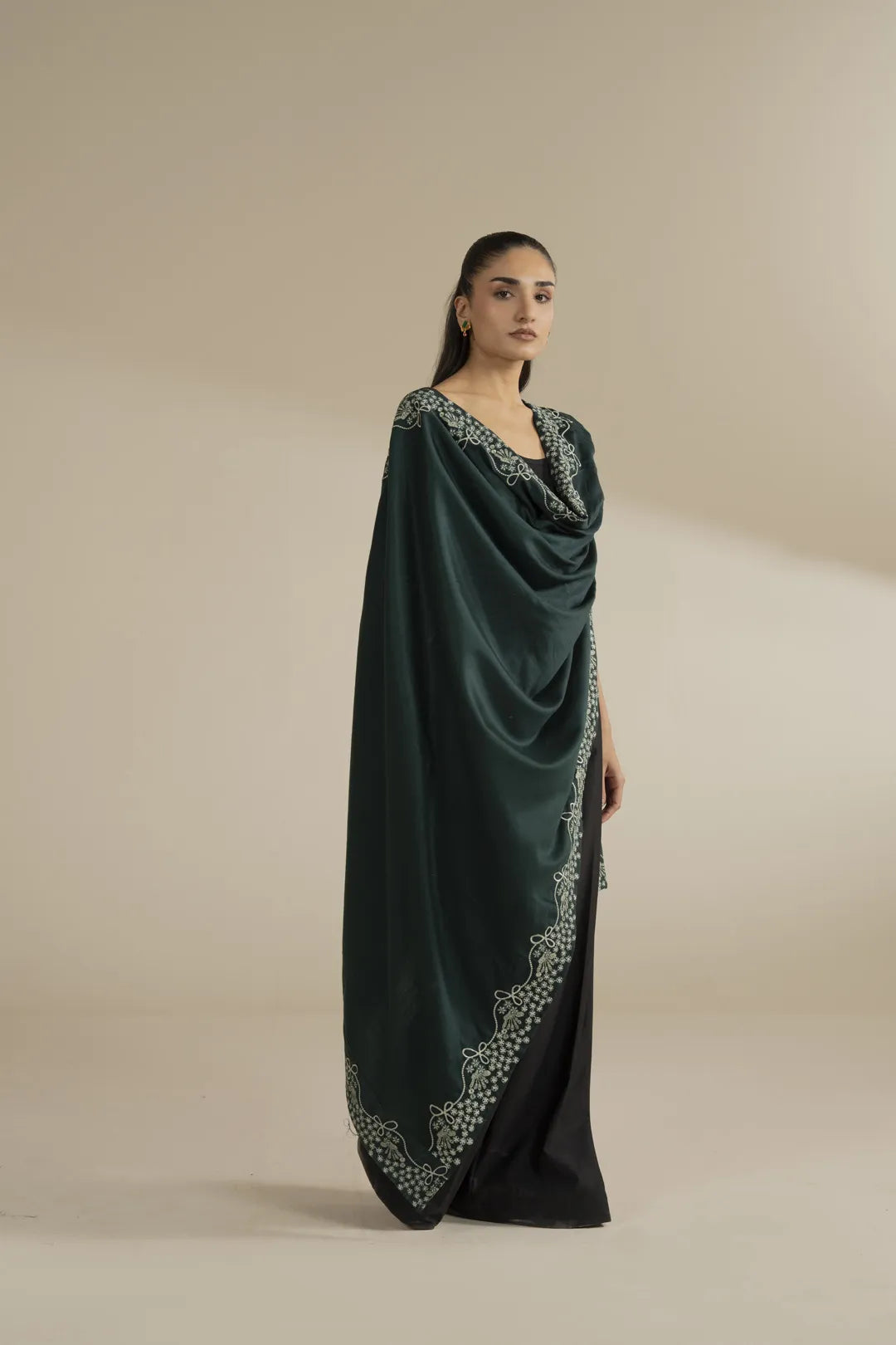 Full-length view of dark green embroidered shawl wrapped around shoulders, highlighting overall print and finish