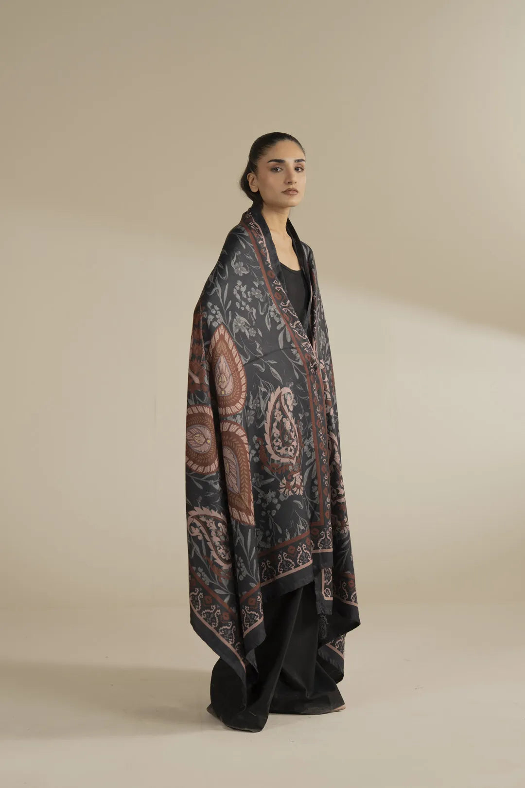 Full-length view of grey printed herringbone shawl styled over a black outfit, showcasing detailed print