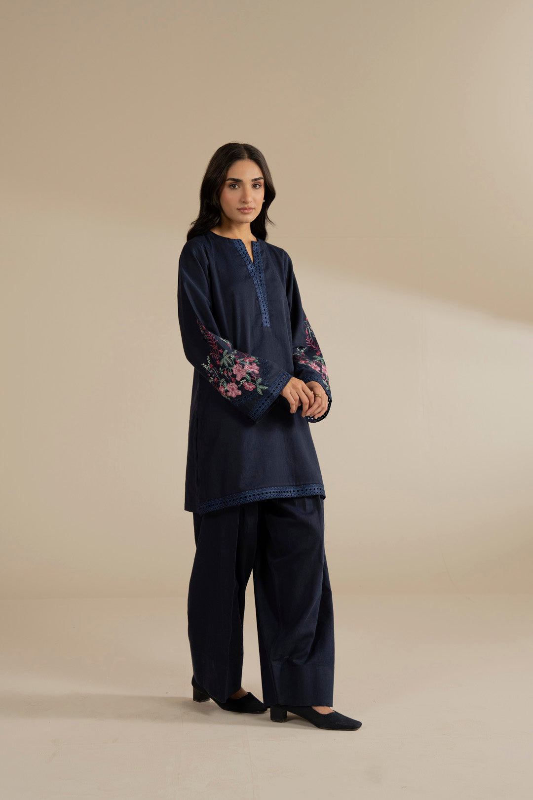 Full-length view of navy blue kurta and trouser set, relaxed fit silhouette.
