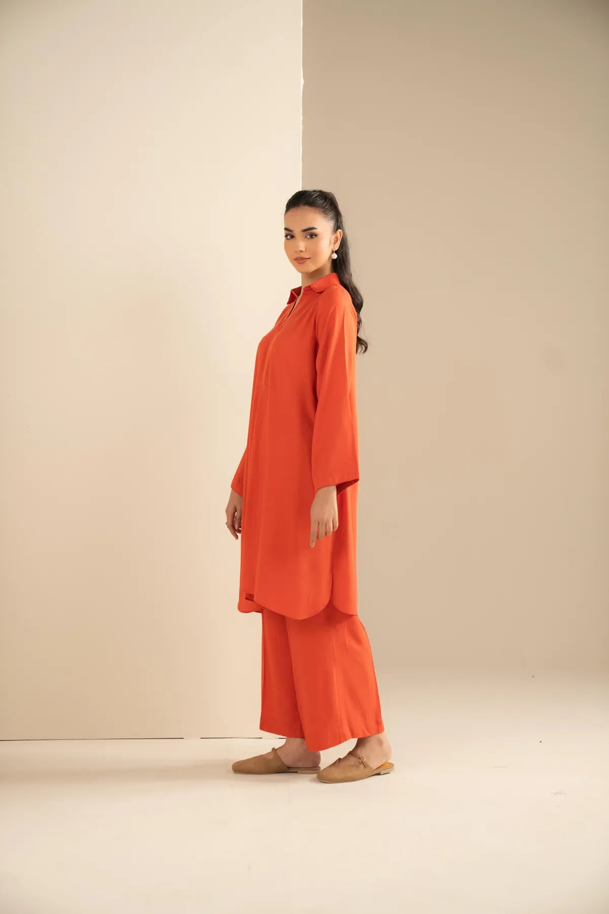 Full-length view of relaxed fit orange co-ord set for women