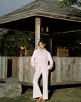 Full-length view of soft pink velvet co-ord set styled with a button-down top and straight pants
