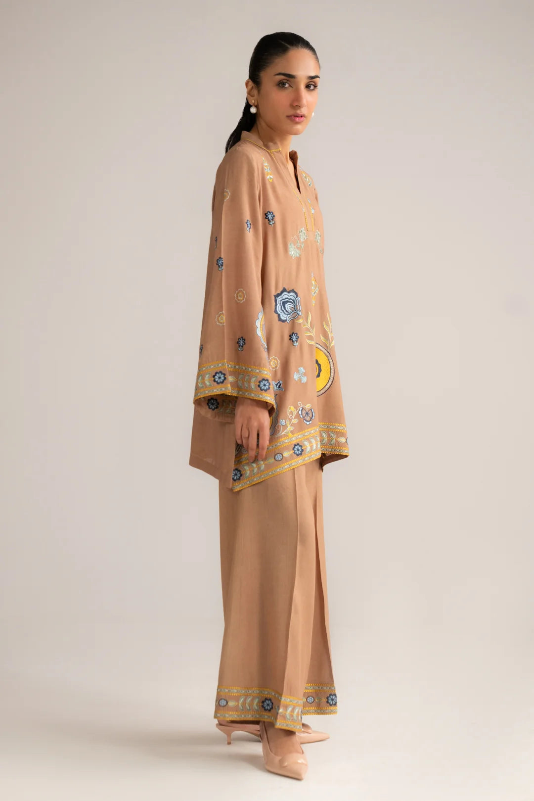 Full-length view of women’s embroidered linen pret set