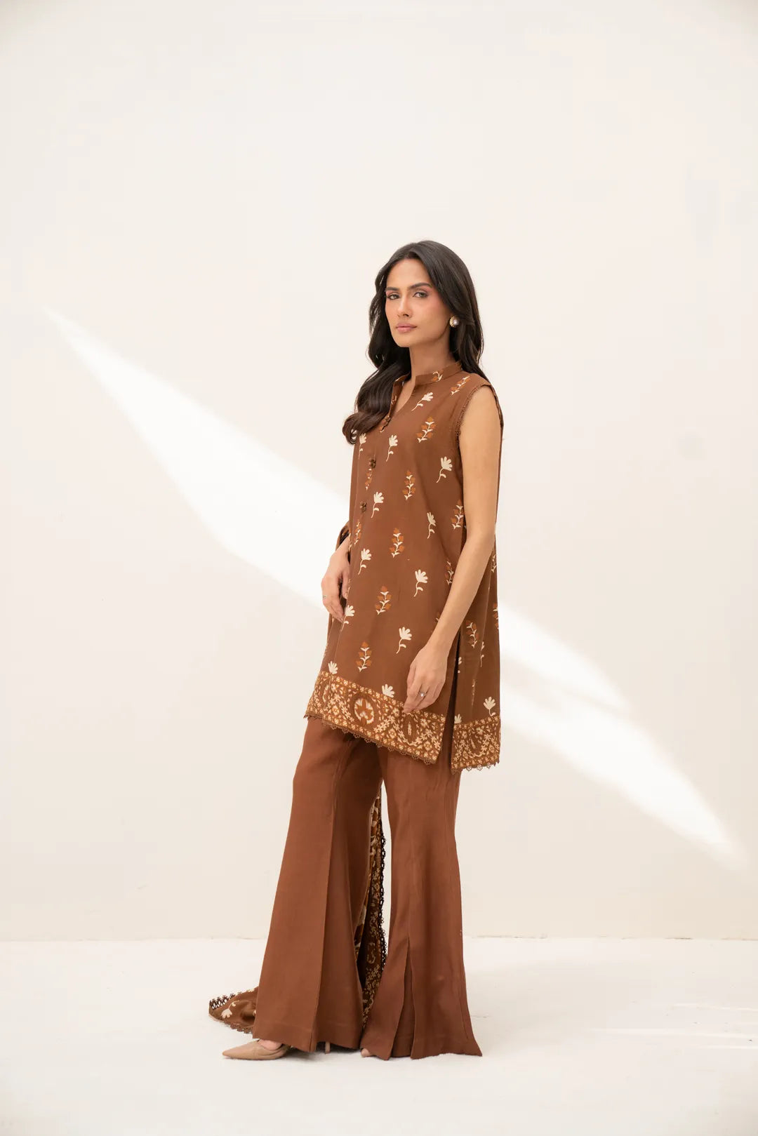 Full outfit shot of brown printed linen 3-piece suit showing silhouette and drape