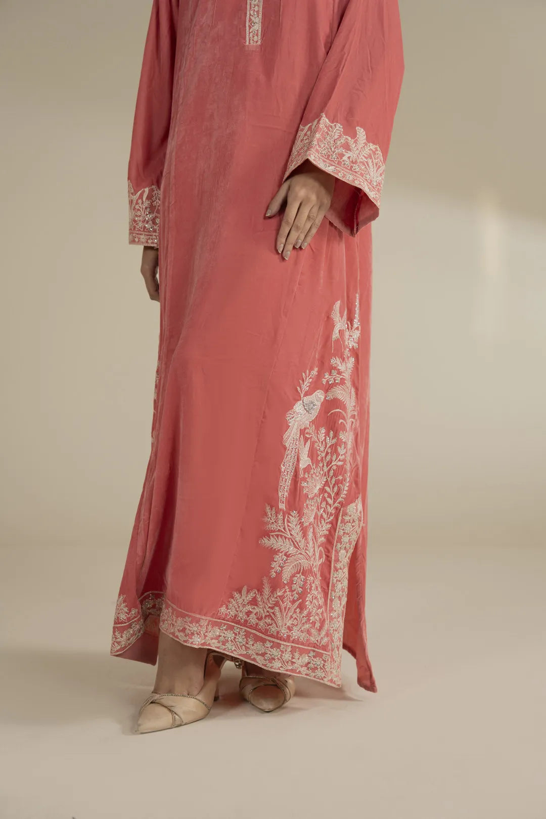 Hem and embroidery finishing on peach velvet kaftan dress