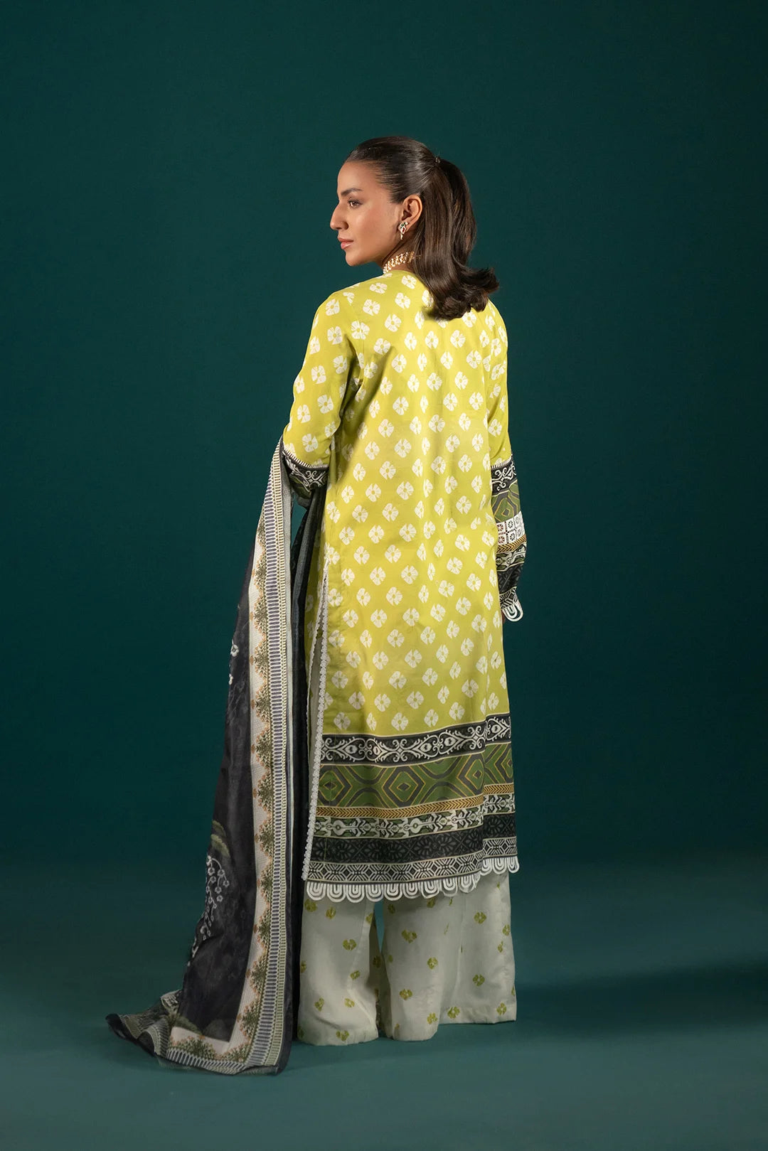 Latest Lawn Suit Design - Printed 3 Piece Dress for Women: This trendy Pakistani lawn suit features a digital printed shirt, comfortable cambric trousers, and a fashionable black dupatta with floral detailing.