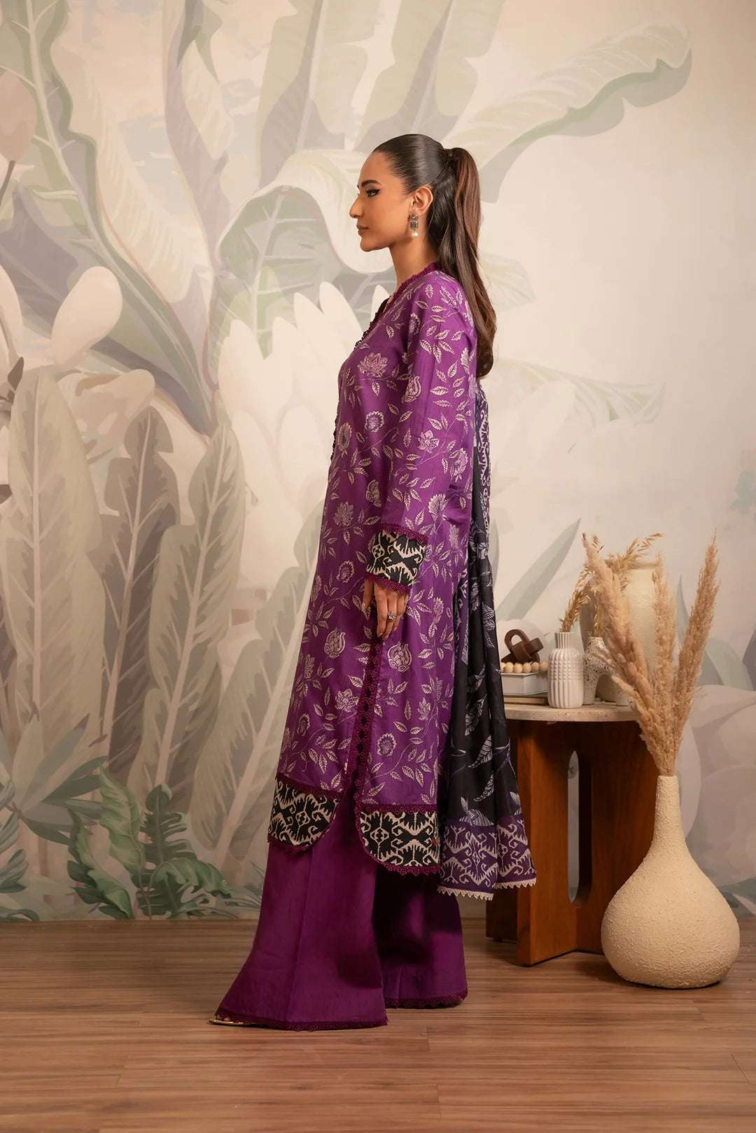 Latest Pakistani lawn suit with digital floral prints, a stylish purple shirt paired with a soft black dupatta adorned with intricate border details.