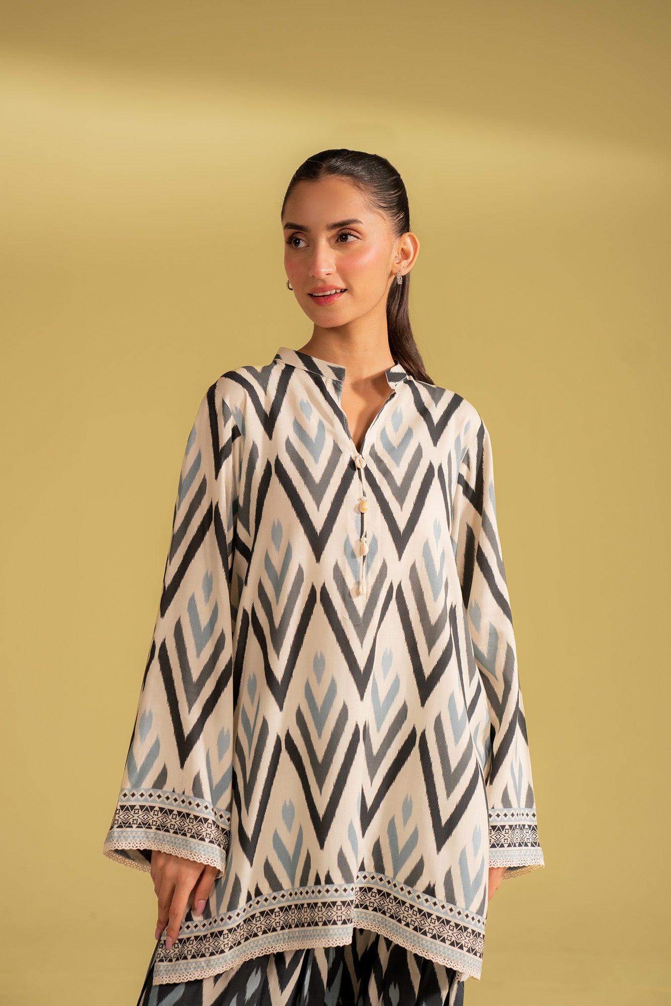 Latest design digital print linen suit, featuring a unique geometric ikat pattern in off-white, black, and blue, available online in Islamabad