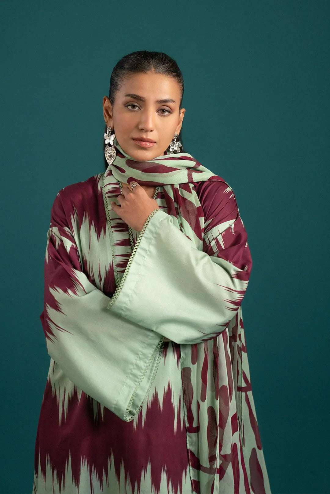 Latest lawn suit design featuring a modern maroon and green abstract printed lawn shirt, complemented by a flowy printed chiffon dupatta.