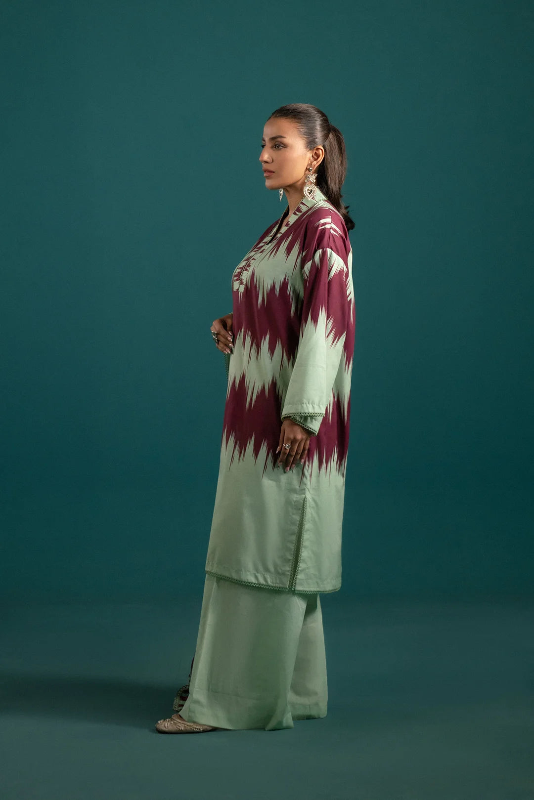 Lawn suit design with a striking maroon and green color contrast, featuring an ikkat print shirt and a flowing printed chiffon dupatta.
