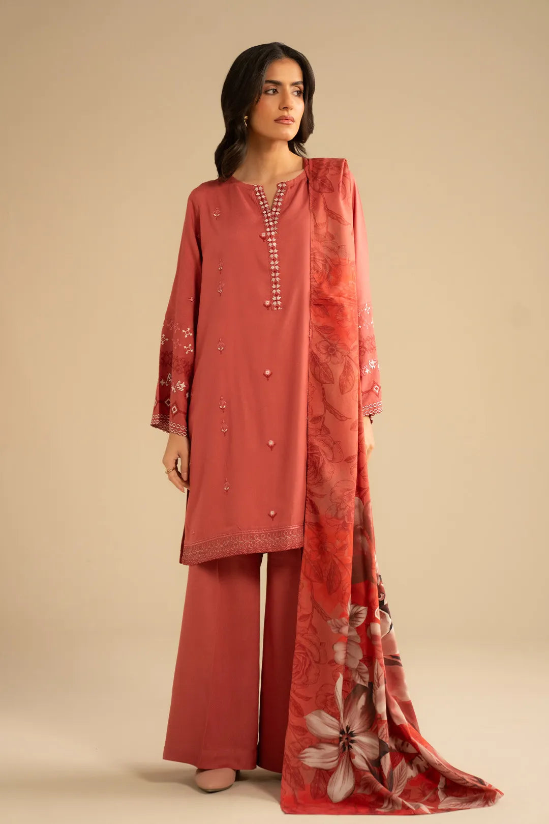 Light orange embroidered linen kurta set styled with a printed shawl, shown in a clean studio look.