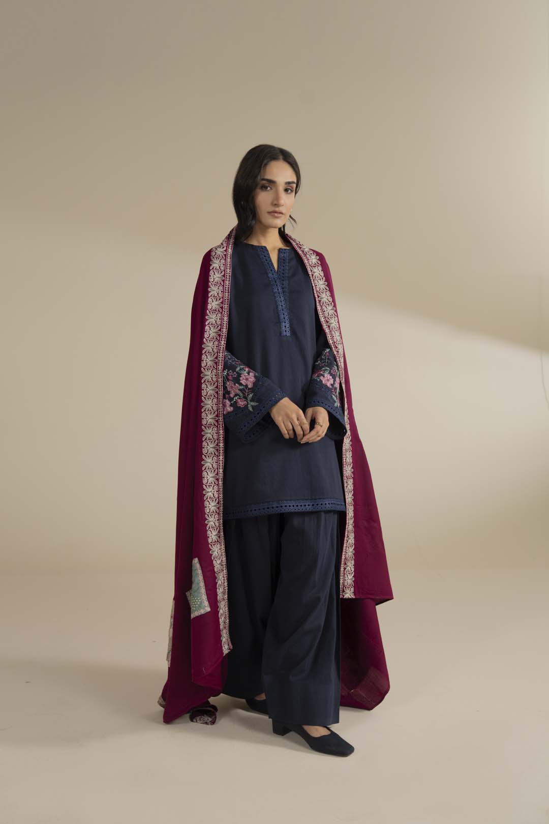 Lower section detail featuring circular motif placement and border finishing on the pink fabric.