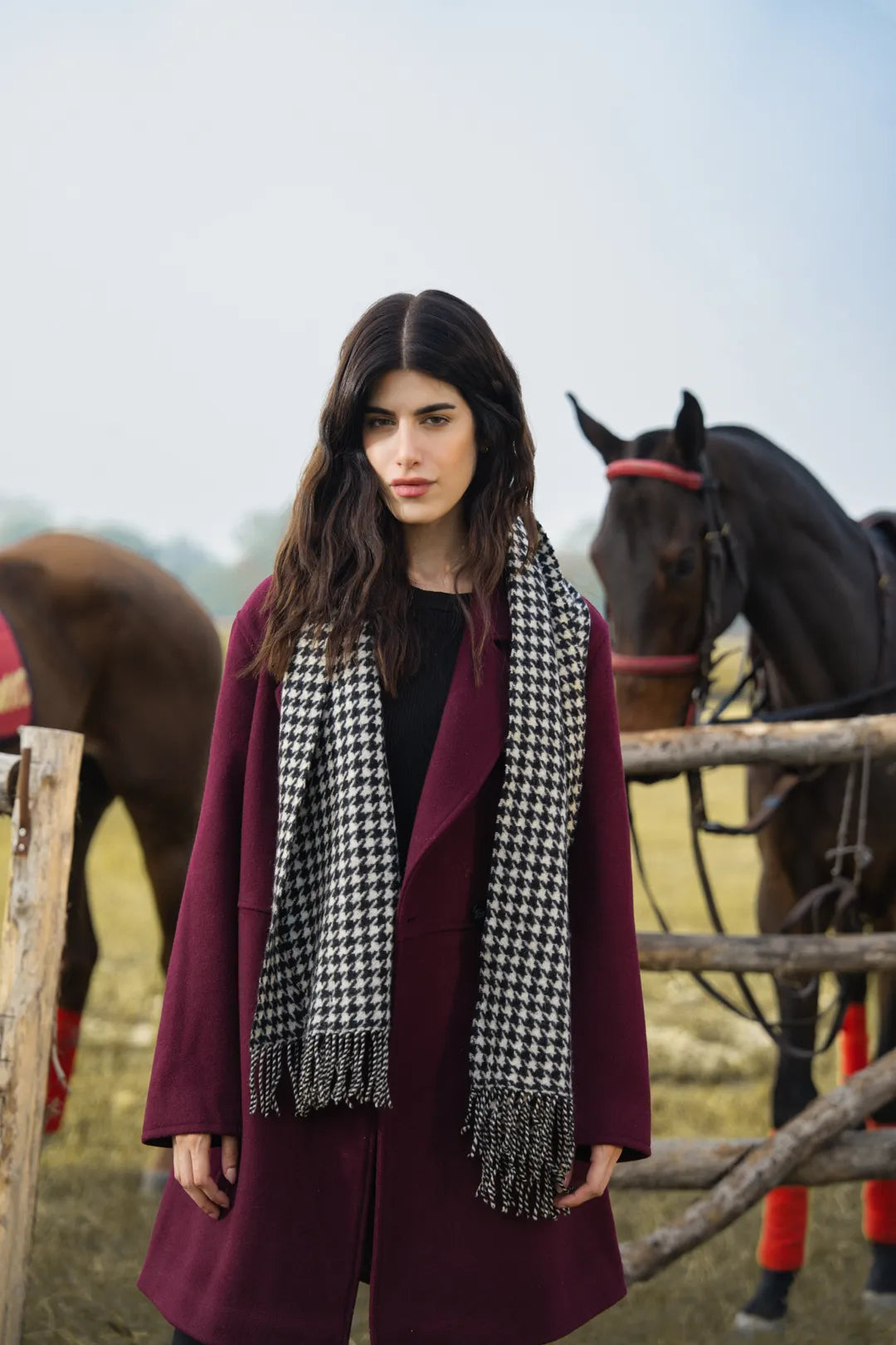 Maroon overcoat for women styled with scarf, winter outfit look