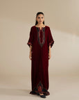 Maroon velvet kaftan with embroidered neckline and wide sleeves, styled as a full-length festive look.