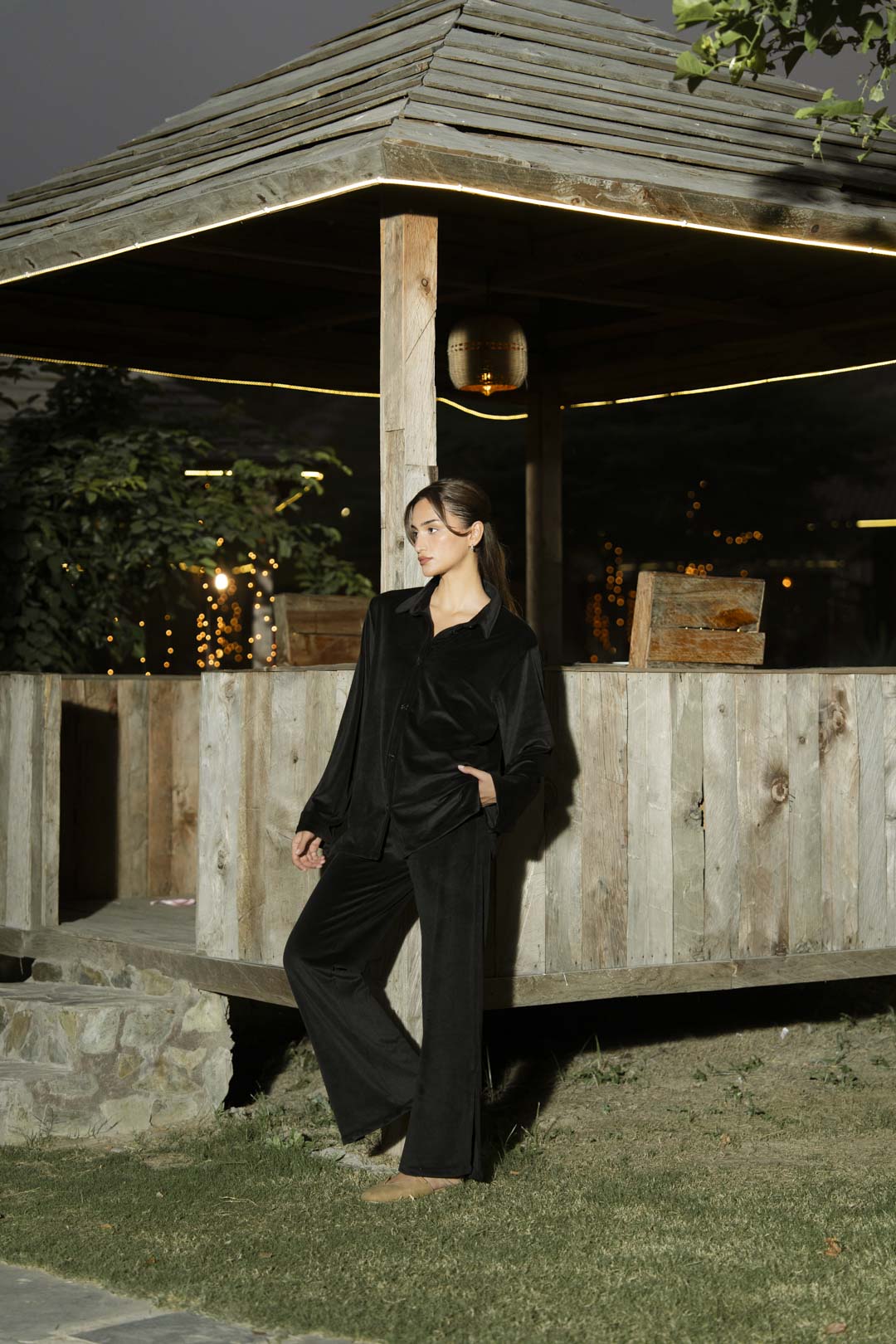 Mid-shot of black velvet co-ord set showing smooth drape and sheen.