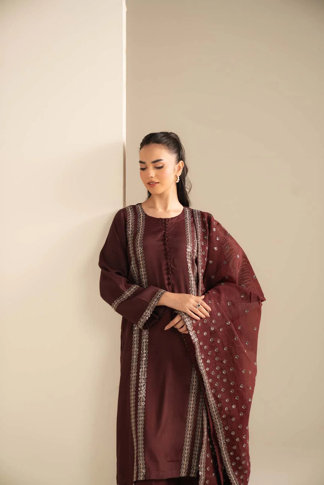 Mid-shot of maroon raw silk suit highlighting front panel and sequin work placement.