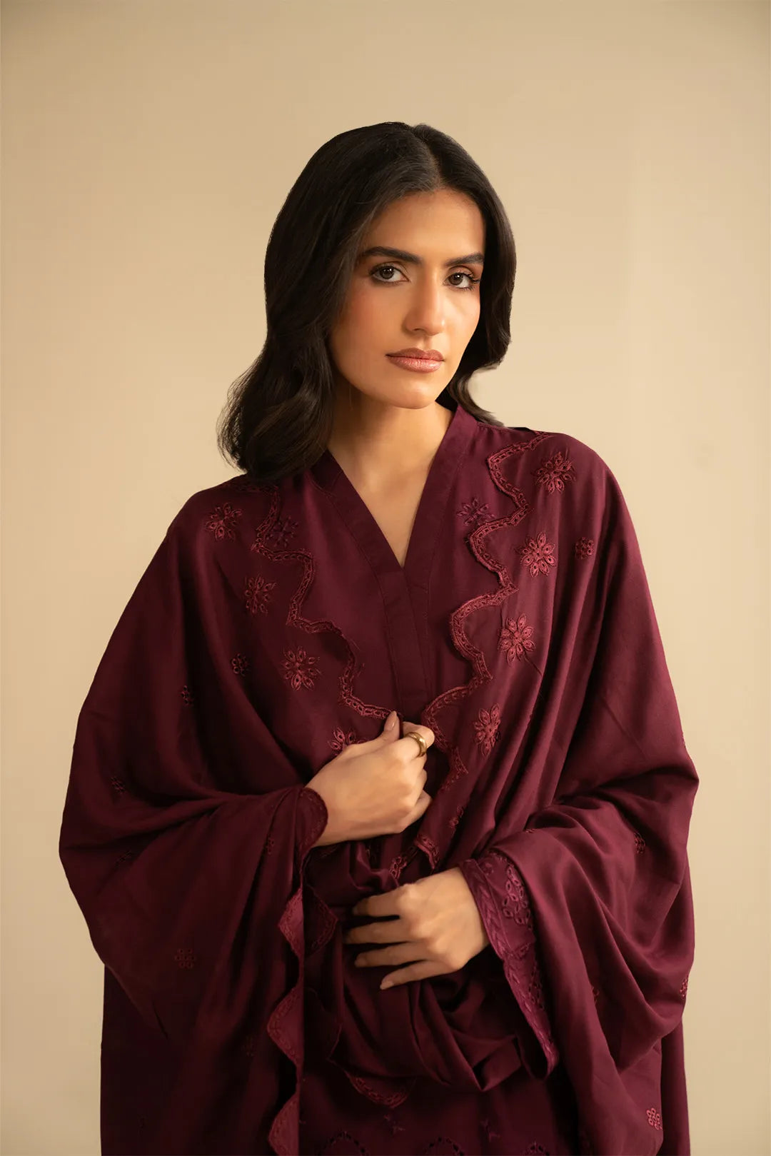 Mid-shot of model in maroon embroidered linen suit highlighting neckline and front embroidery placement.