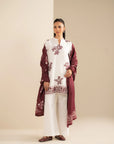 Model in unstitched 3 piece embroidered khaddar suit with maroon shawl
