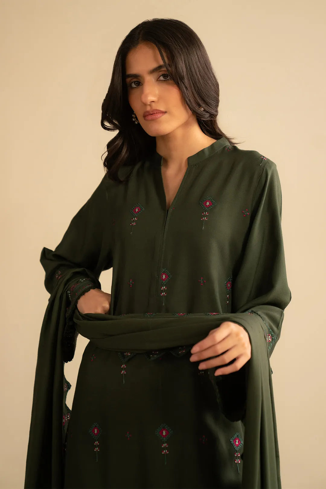 Model pose in green embroidered linen 3-piece set, mid-shot showing front embroidery and clean styling.