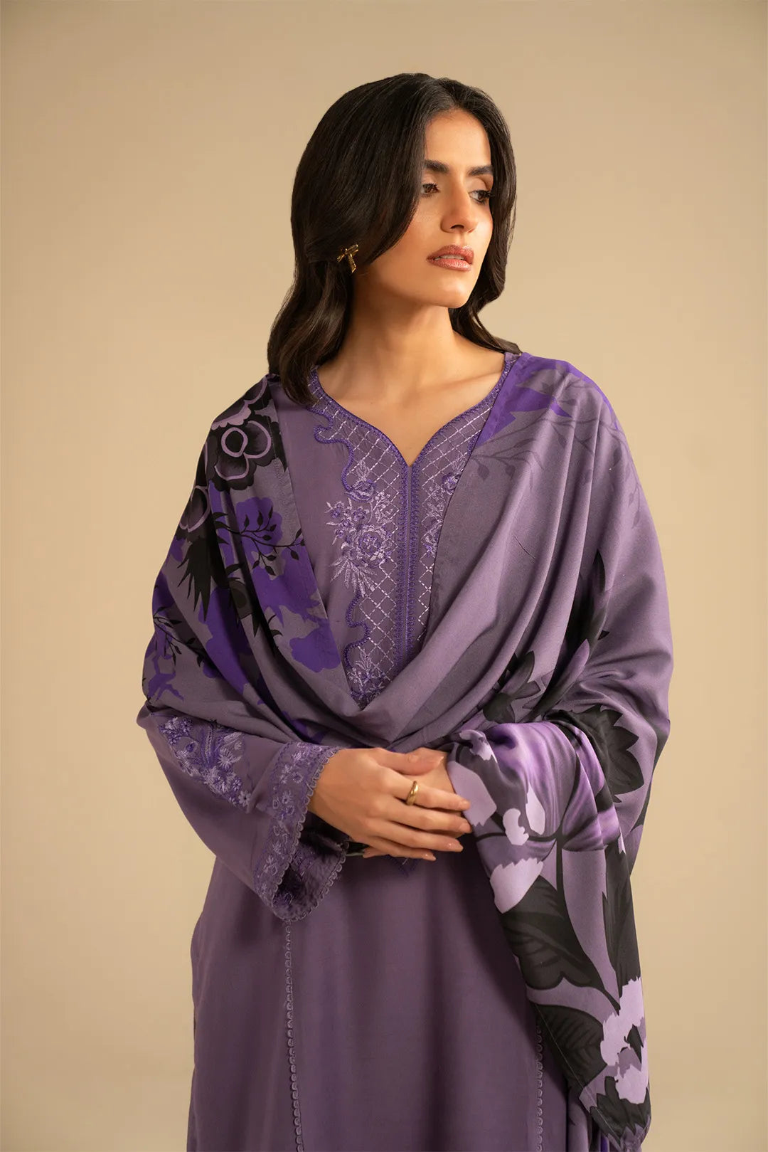 Model styled in light purple embroidered linen suit with printed shawl draped over shoulders, front pose
