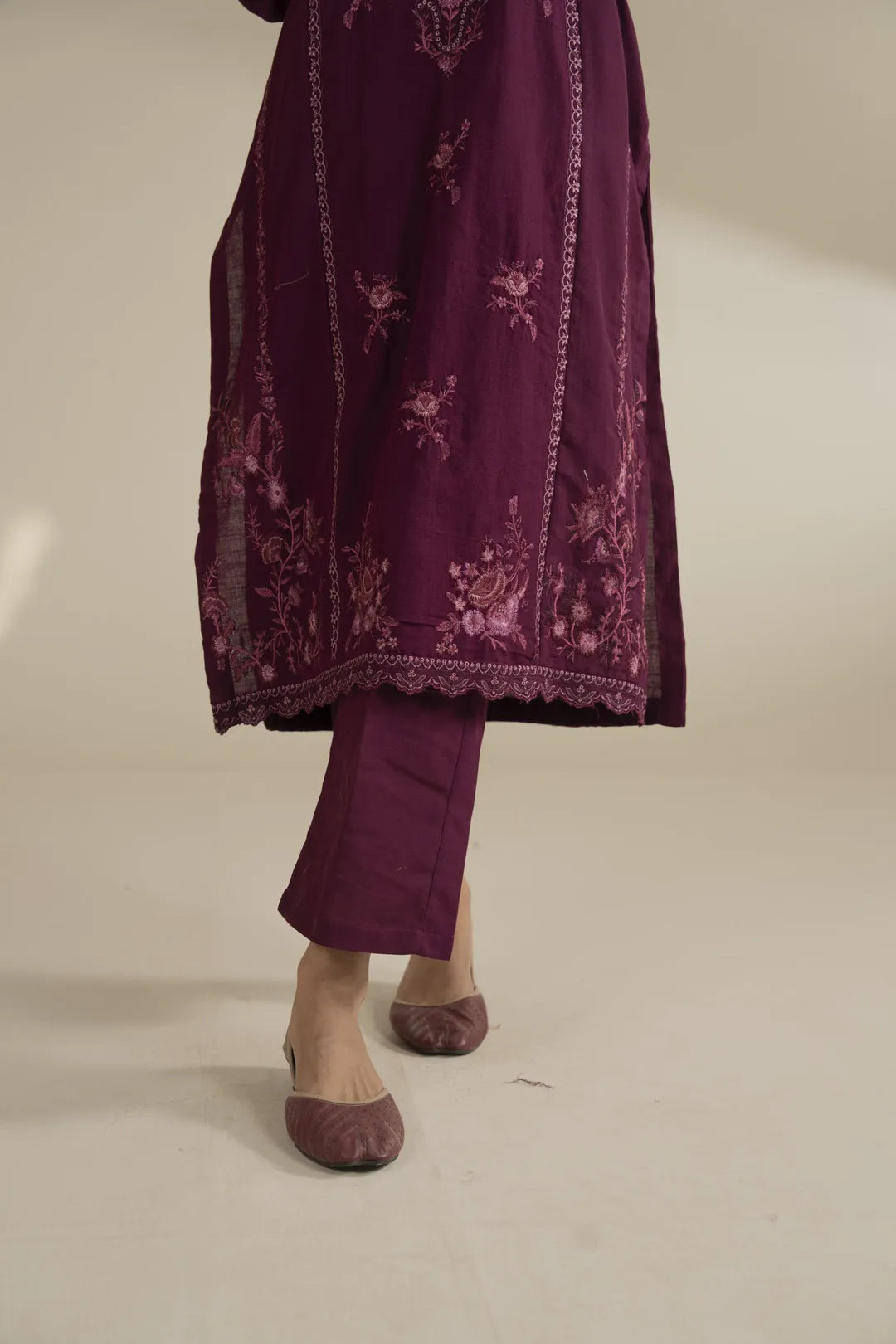 Model styling the pink khaddar 2 piece suit for winter wear in Pakistan, minimal accessories.