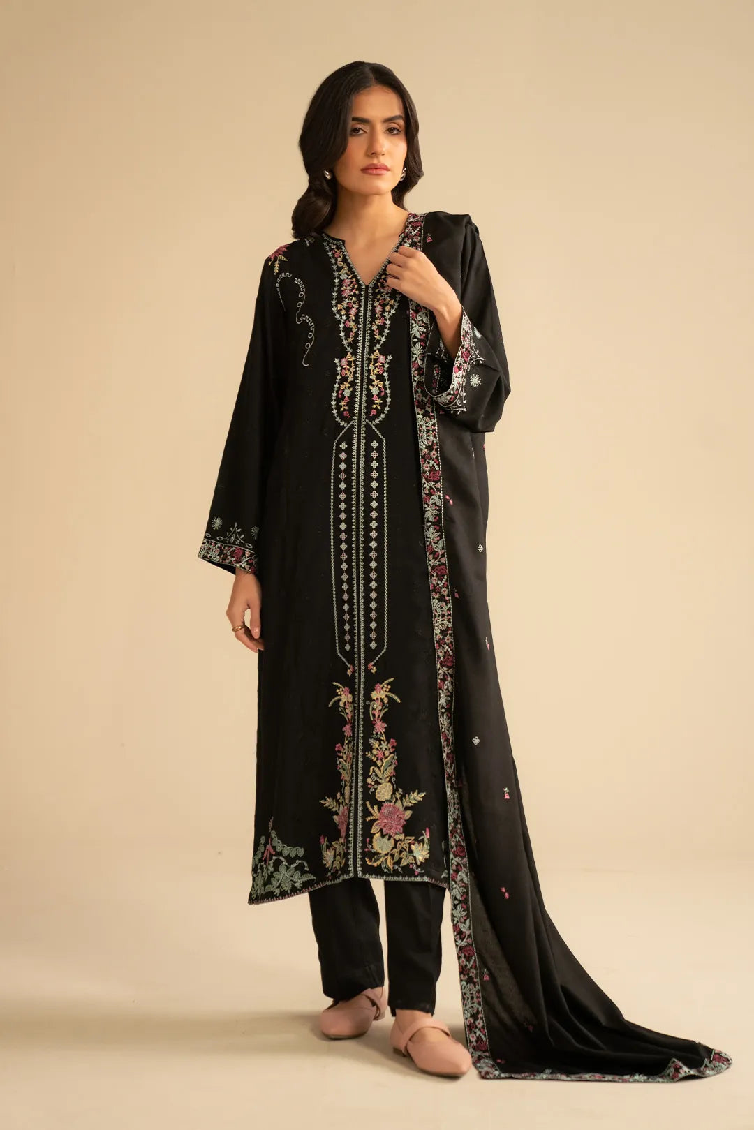 Model wearing black 3 piece embroidered linen suit with pastel embroidery and matching dupatta, full front view