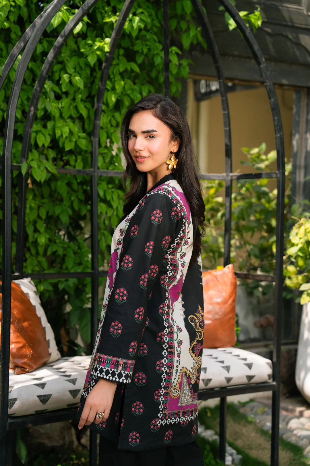 Model wearing black printed 1 piece cambric shirt with pink accents